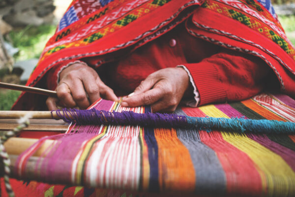 Close up of a woman weaving in Peru